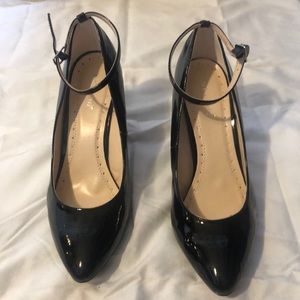 Black faux patent leather wedge heel.